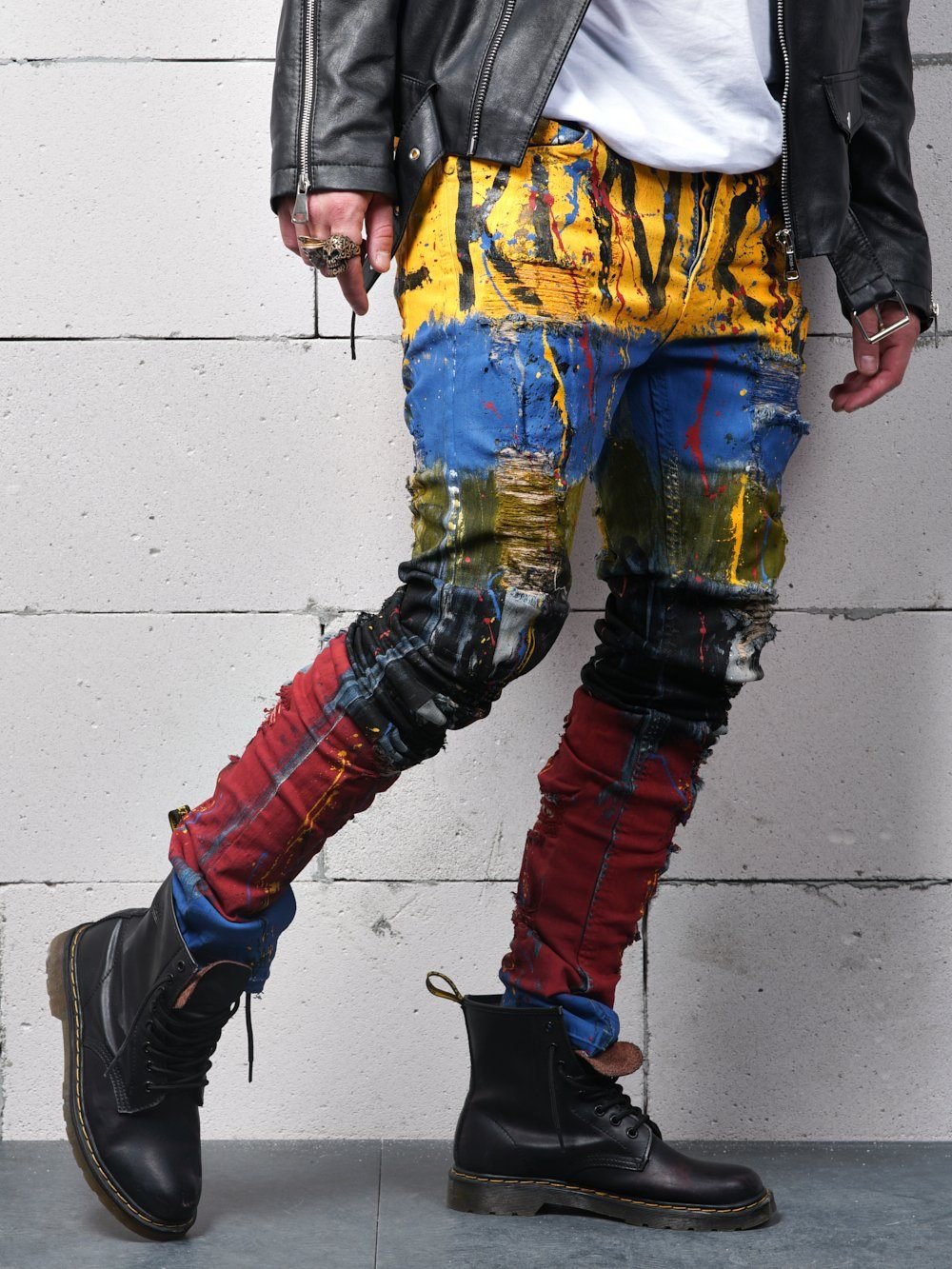 A man wearing a pair of TOO MUCH jeans and a leather jacket.