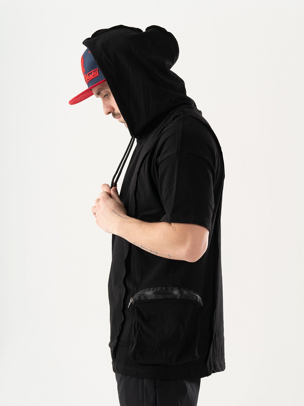 A man sporting a stylish [BLACKFURY HOODIE] and hat.