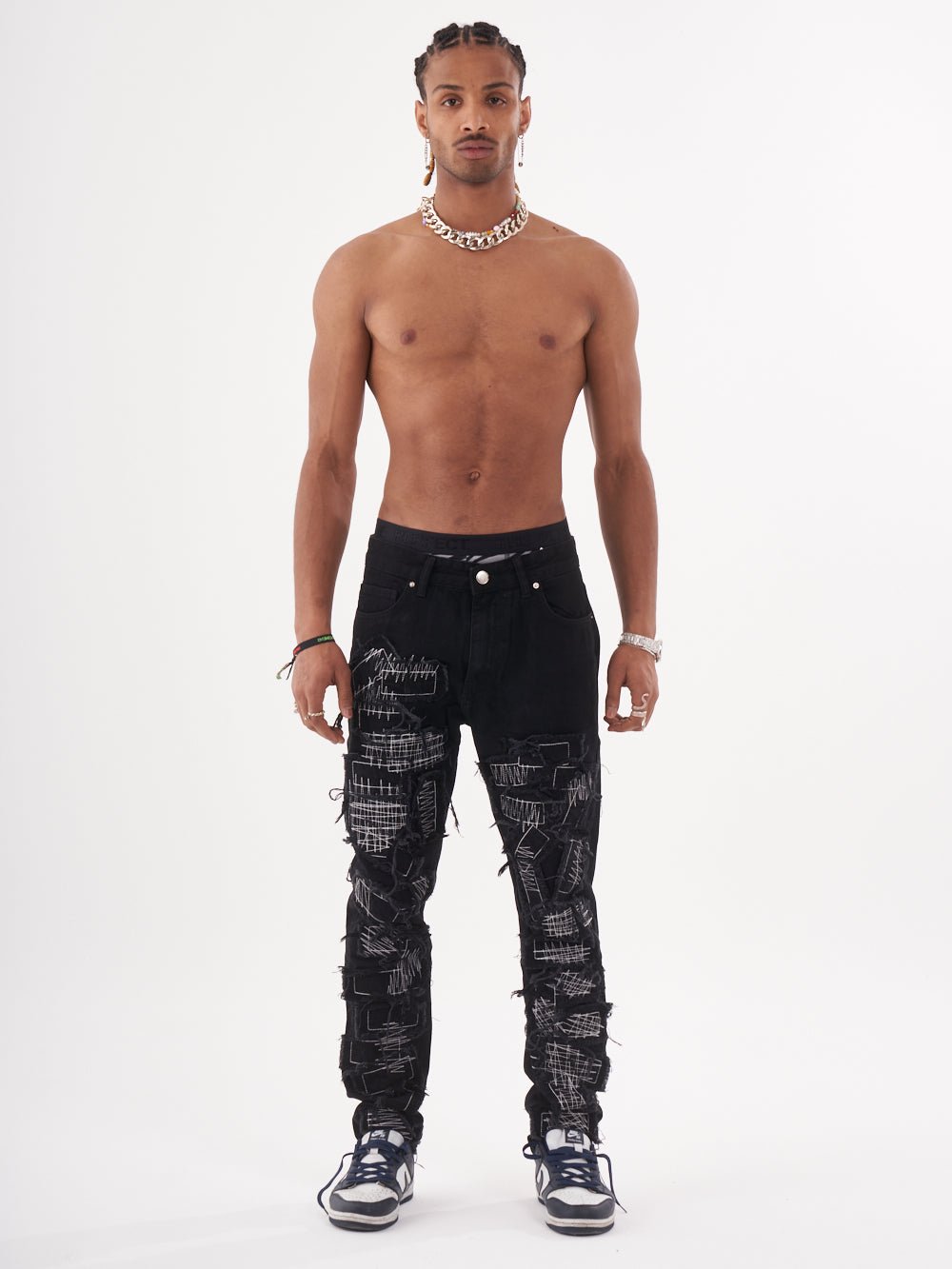 Full body shot of a man in a black color BLUEPRINT streetwear jeans by SERNES